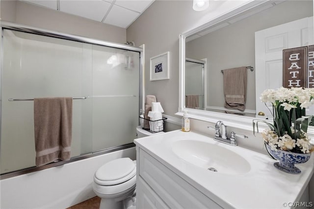 full bathroom with vanity, toilet, and combined bath / shower with glass door