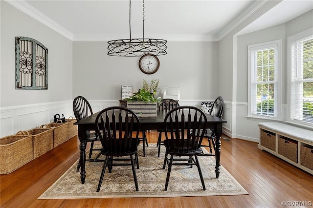 dining area featuring ornamental molding and light wood-type flooring