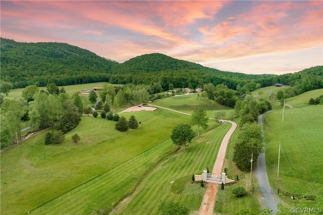 aerial view at dusk with a mountain view and a rural view