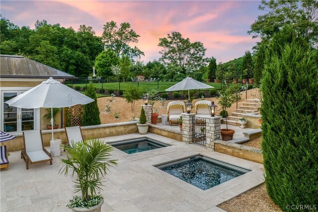 4578 Ruth Rd, Madison, VA 22727 - pool at dusk featuring an in ground hot tub and a patio