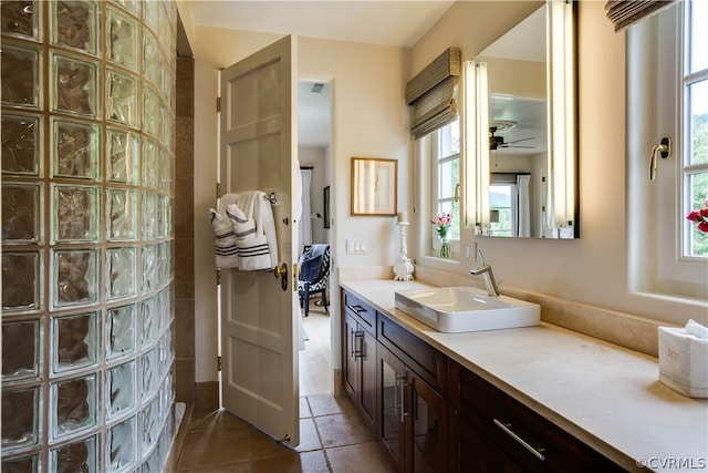 bathroom with tile floors, vanity, and ceiling fan