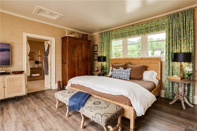 bedroom with hardwood / wood-style flooring and ornamental molding