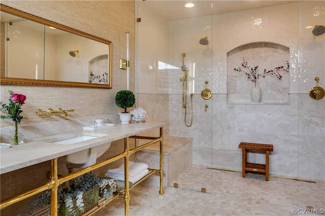 bathroom with tiled shower and tile walls