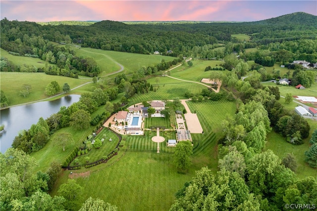 aerial view at dusk with a water view