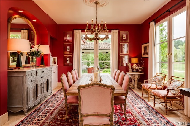 tiled dining room featuring an inviting chandelier