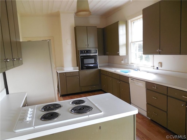 kitchen featuring white appliances, dark wood-type flooring, and sink