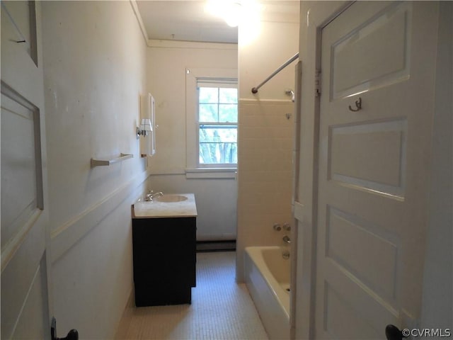 bathroom with ornamental molding, bathtub / shower combination, vanity, and a baseboard heating unit