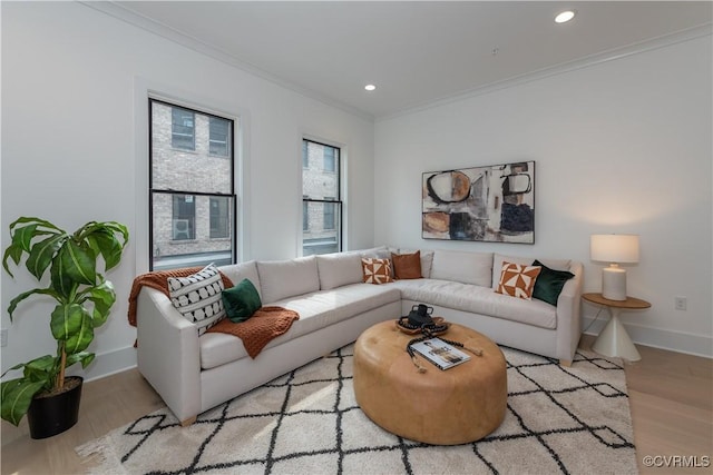 living area with recessed lighting, baseboards, light wood finished floors, and ornamental molding