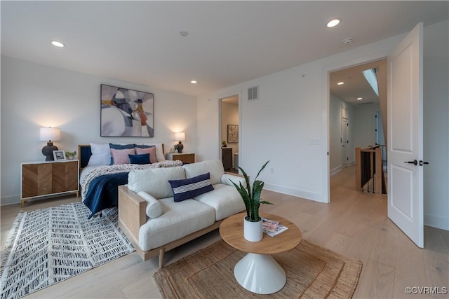 bedroom with visible vents, recessed lighting, light wood-type flooring, and baseboards