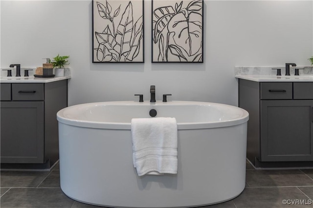 full bathroom featuring tile patterned flooring, vanity, and a freestanding bath