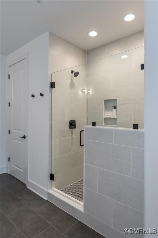 bathroom with tile patterned flooring, recessed lighting, and a stall shower