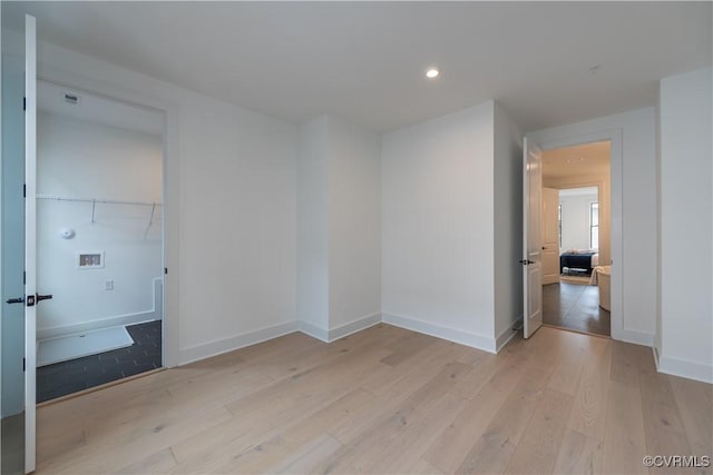 unfurnished bedroom with recessed lighting, baseboards, and light wood-style flooring