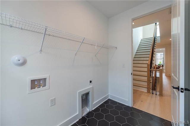 laundry area featuring washer hookup, laundry area, baseboards, and hookup for an electric dryer