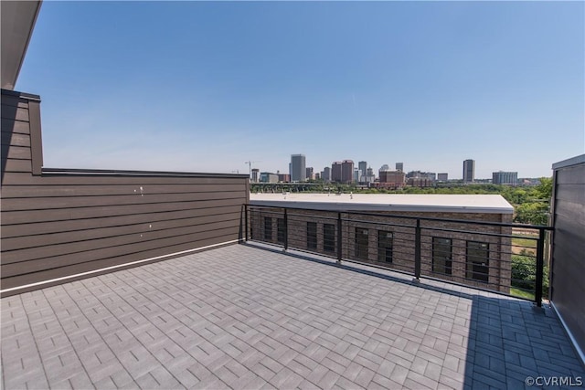 view of patio featuring a view of city and a balcony