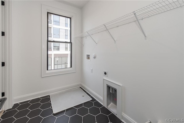 laundry area with hookup for a gas dryer, baseboards, hookup for an electric dryer, hookup for a washing machine, and laundry area