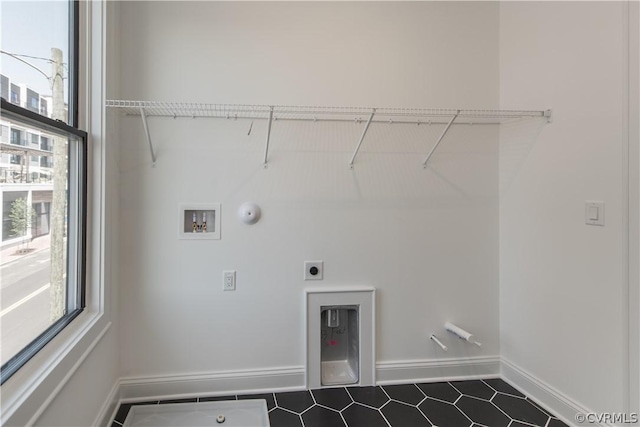 clothes washing area with baseboards, gas dryer hookup, washer hookup, laundry area, and hookup for an electric dryer