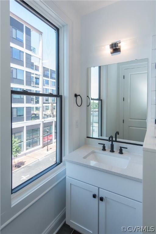 bathroom featuring a healthy amount of sunlight and vanity