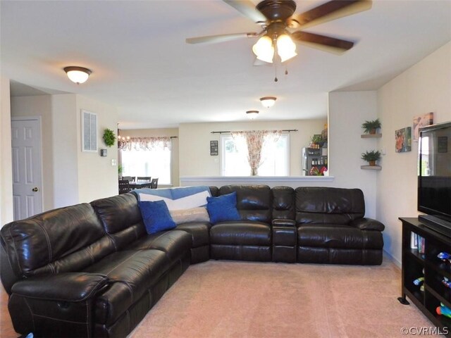 carpeted living room with ceiling fan