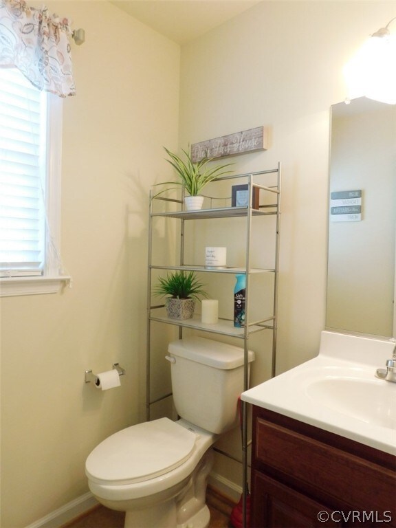 bathroom featuring toilet and vanity