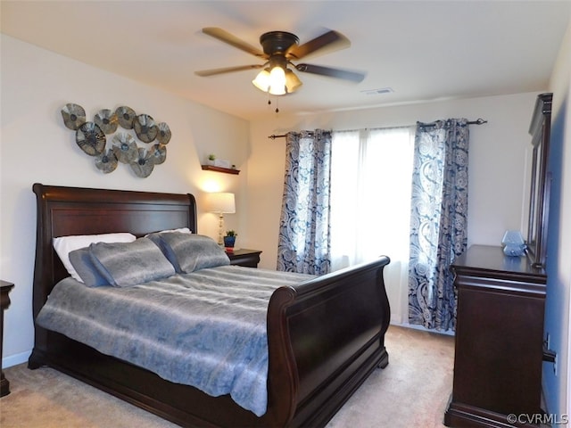 bedroom with light carpet and ceiling fan