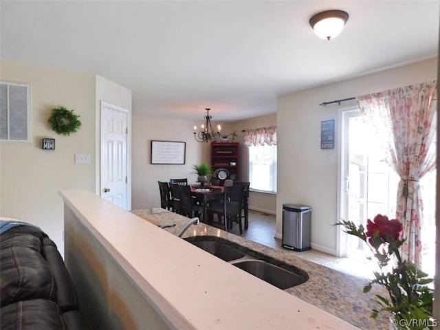 living room with sink and an inviting chandelier