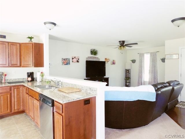 kitchen with ceiling fan, kitchen peninsula, stainless steel dishwasher, light tile floors, and sink