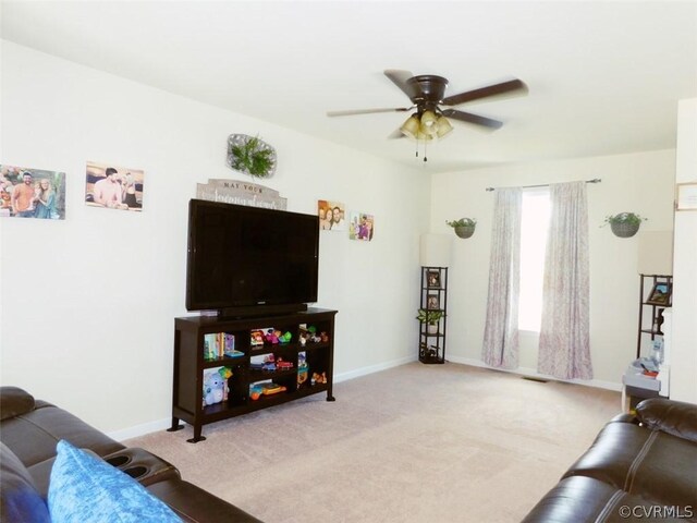 carpeted living room with ceiling fan