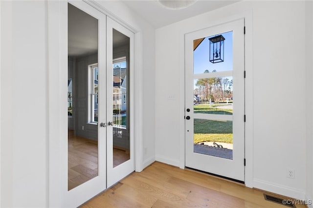 doorway featuring light hardwood / wood-style floors and french doors