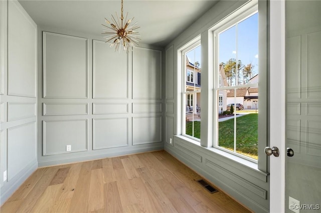 unfurnished sunroom featuring a chandelier