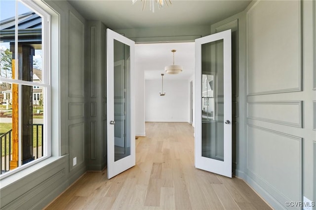 doorway to outside with light hardwood / wood-style flooring and french doors