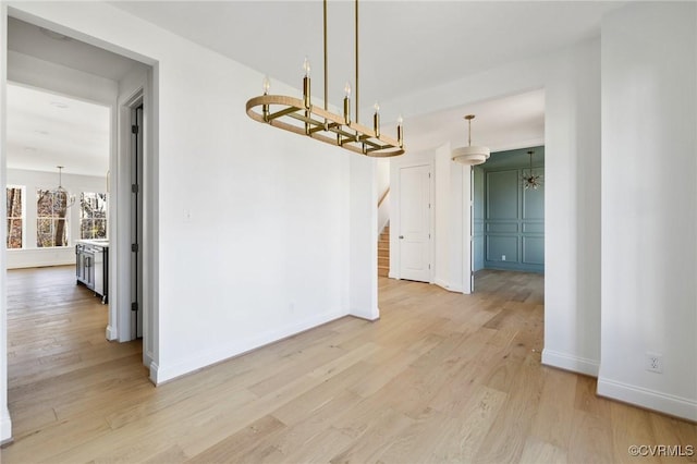 unfurnished dining area featuring light wood-type flooring