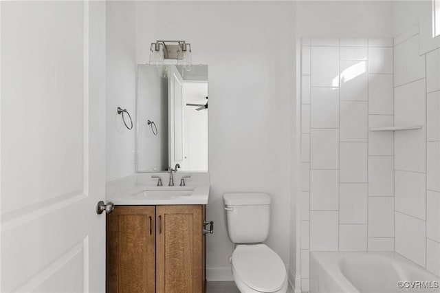 full bathroom featuring vanity, toilet, ceiling fan, and tiled shower / bath combo