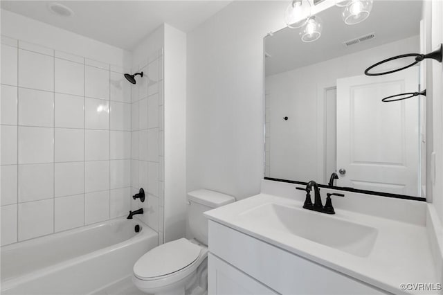 full bathroom featuring toilet, vanity, and tiled shower / bath