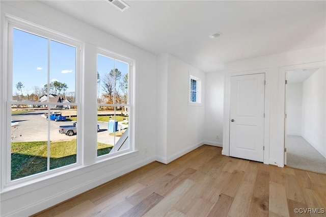 unfurnished room featuring light hardwood / wood-style floors