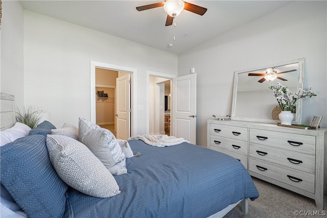 carpeted bedroom with ceiling fan and lofted ceiling