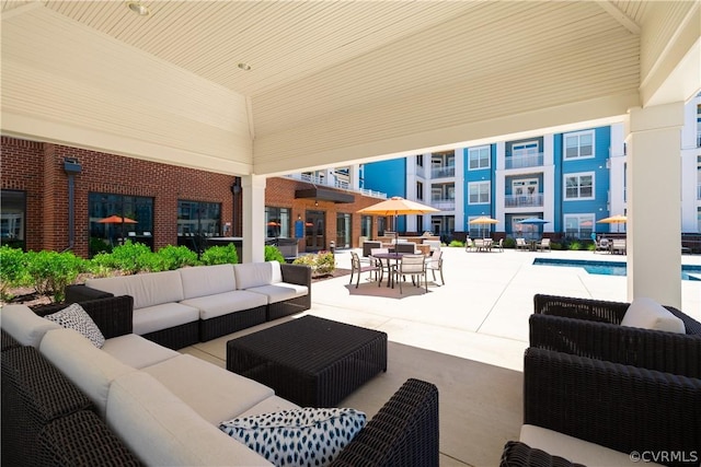 view of patio featuring an outdoor living space and a community pool