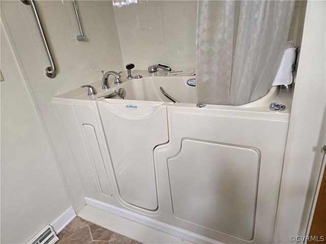 bathroom with tile patterned flooring and a baseboard radiator