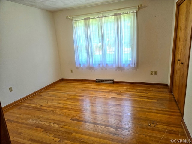 unfurnished bedroom with hardwood / wood-style flooring