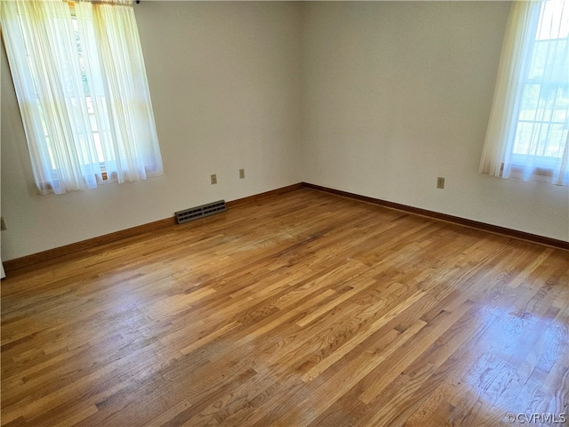 unfurnished room featuring hardwood / wood-style flooring