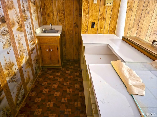 bathroom featuring wood walls and vanity