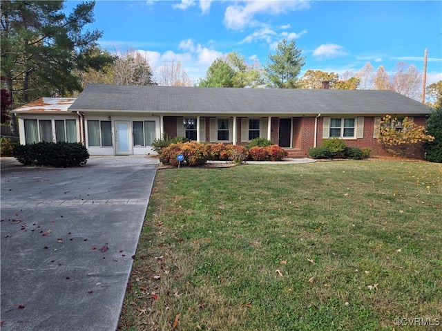 ranch-style home with a front lawn