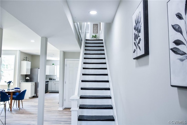 stairs featuring wood-type flooring