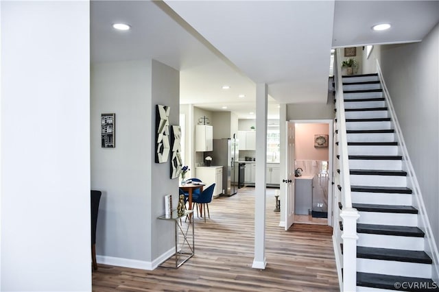 staircase with wood-type flooring