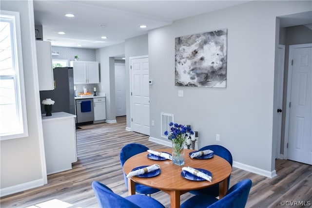 dining space featuring wood-type flooring