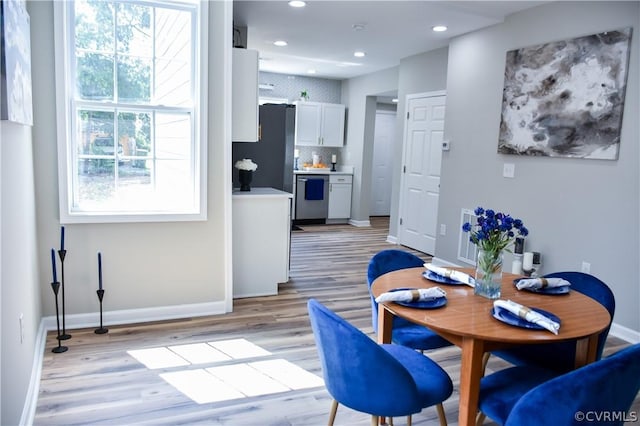 dining space with light wood-type flooring