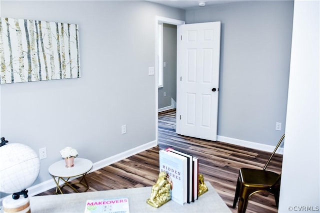 sitting room with dark wood-type flooring