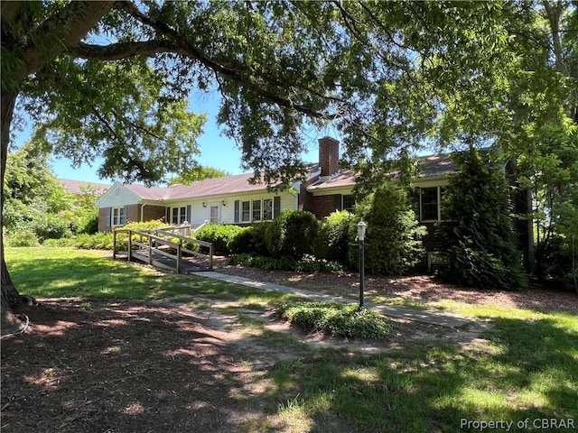 rear view of property featuring a yard