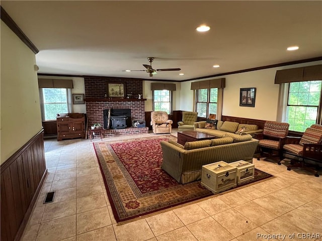 tiled living room featuring crown molding and ceiling fan