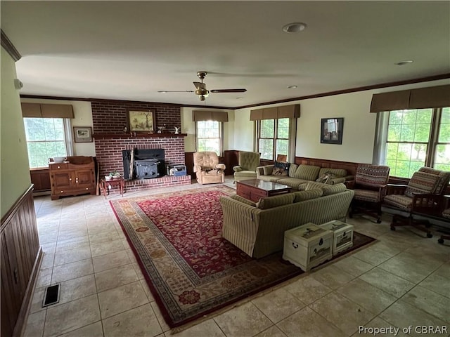 tiled living room with crown molding, a wealth of natural light, and ceiling fan