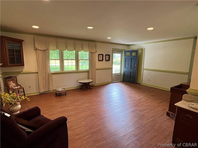 living room featuring crown molding and hardwood / wood-style floors